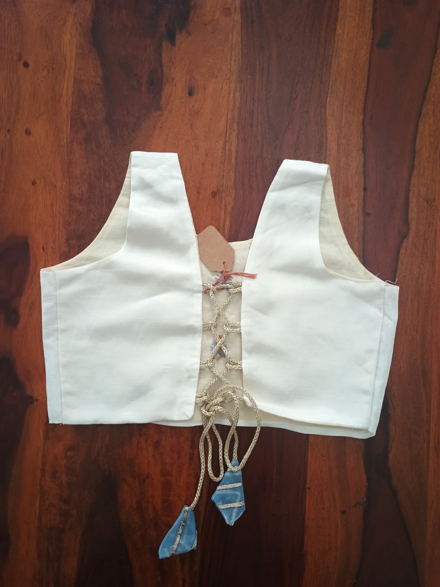 Sleeveless crop top in cream linen satin and organza sky blue skirt.