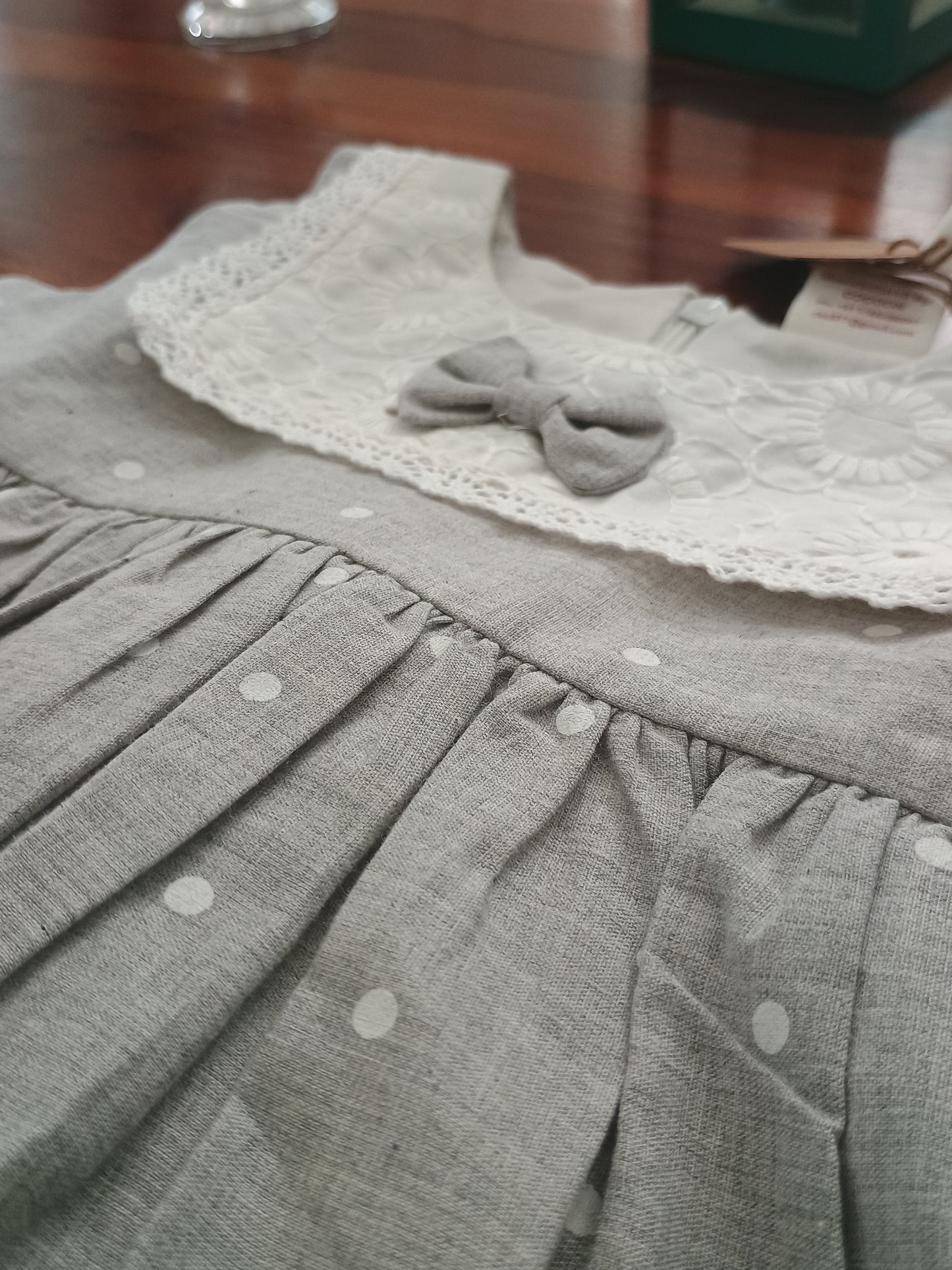 Sleeveless grey white polka frock.