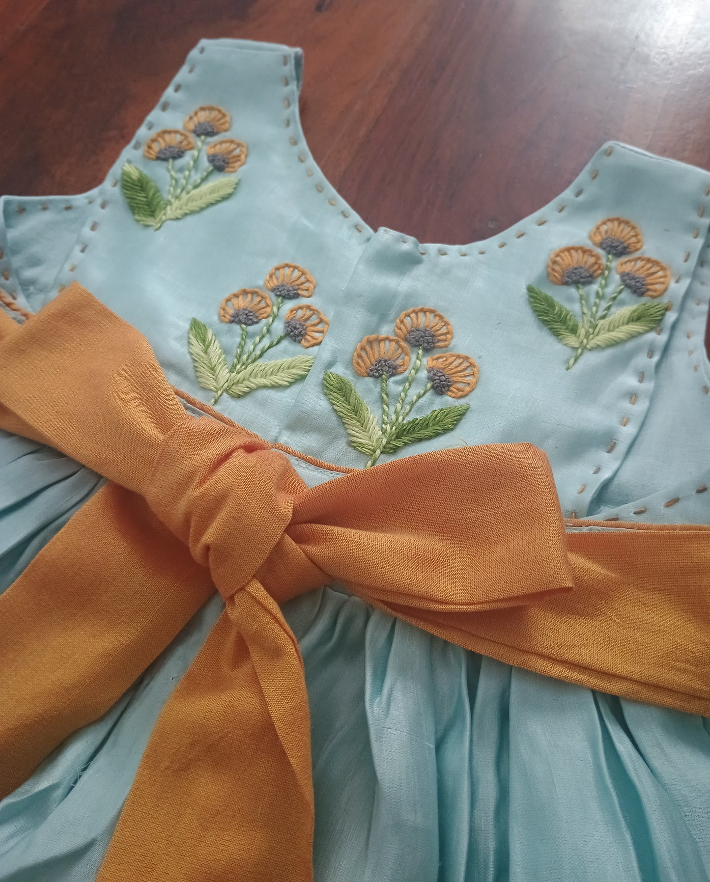 Sleeveless linen satin light blue gathered frock with embroidery