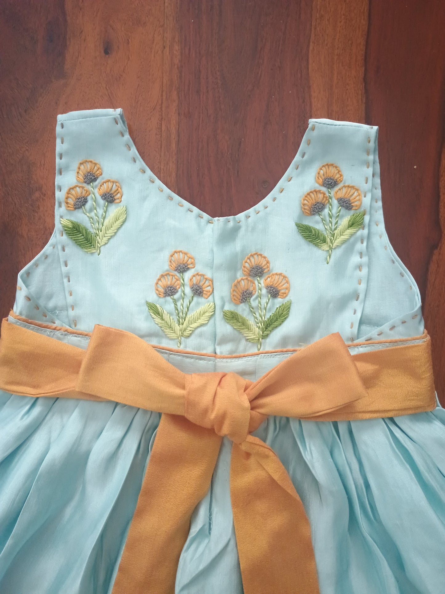 Sleeveless linen satin light blue gathered frock with embroidery